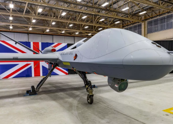 Royal Air Force drone displayed in hangar with Union Jack backdrop