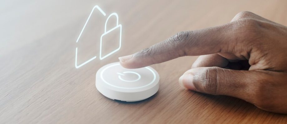 A hand activating a button with a house symbol, representing home-related functions or services
