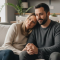 Happy couple relaxing on a cosy sofa in a modern living room with books and plants in the background