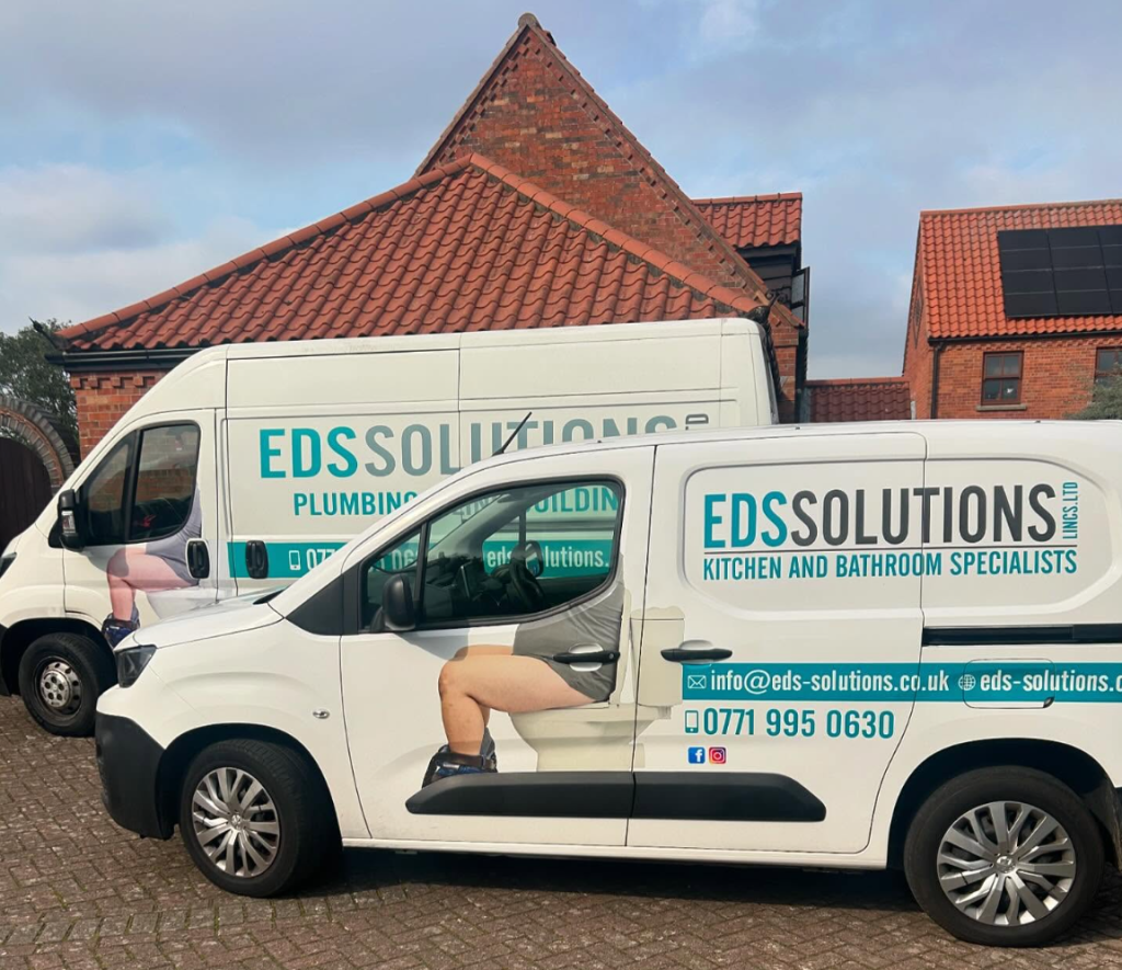 EDS Solutions vans parked outside brick buildings, showcasing plumbing and bathroom specialist services