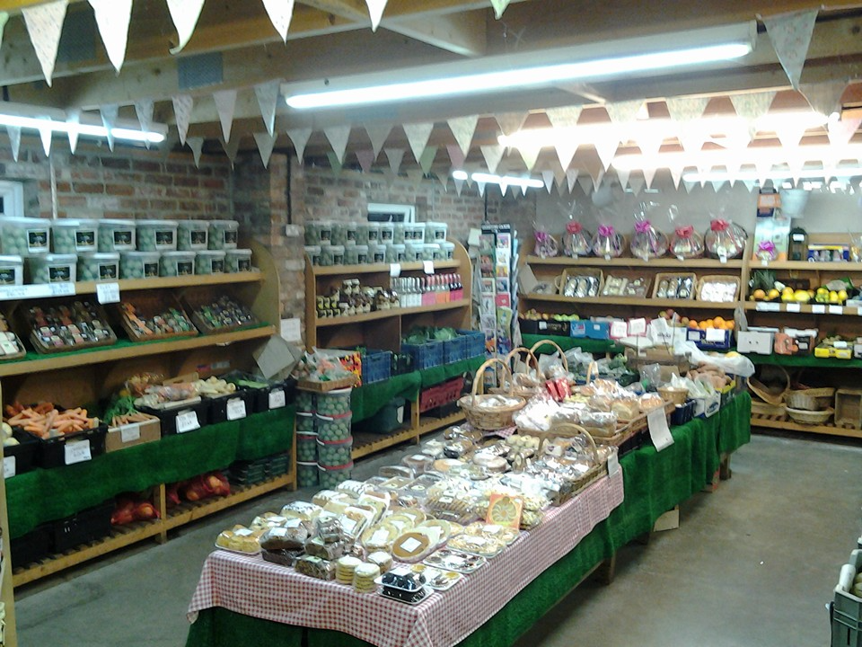 Farm shop with baskets of fresh produce and homemade goods under bunting decoration