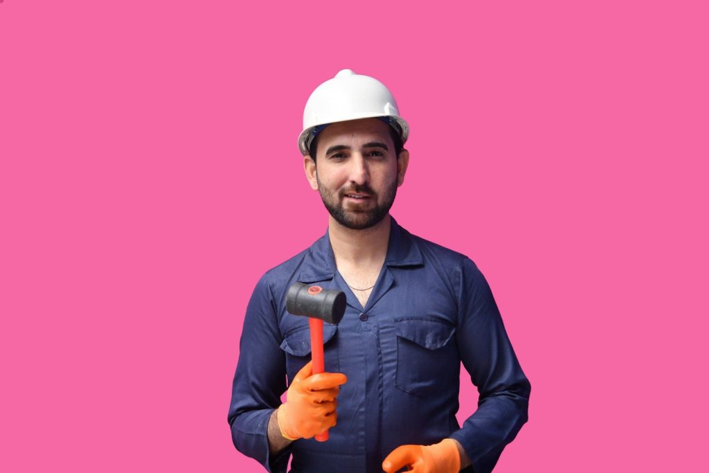 a man wearing a hard hat and holding a microphone