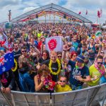 Lively outdoor crowd enjoying a summer music festival at Bloemendaal aan Zee, Netherlands.