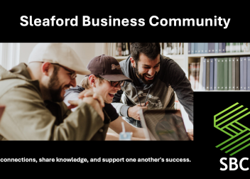 Men laughing around a laptop, promoting collaboration in the Sleaford Business Community meeting space