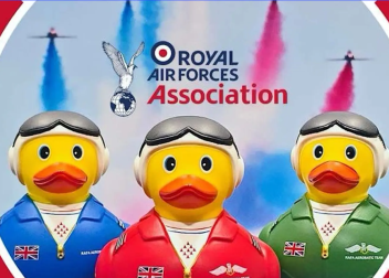 RAF Association rubber ducks with aviation gear and coloured smoke trails in sky background