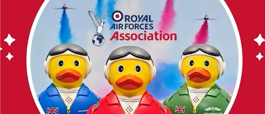 RAF Association rubber ducks with aviation gear and coloured smoke trails in sky background