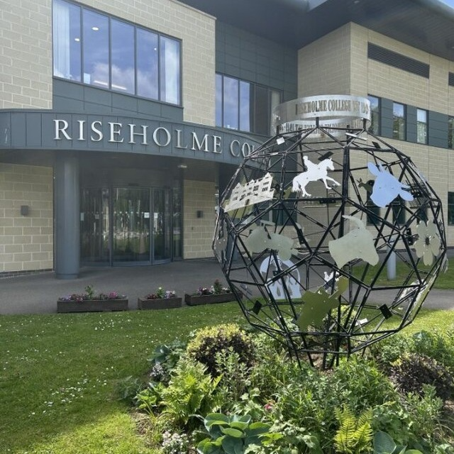 Riseholme College entrance with modern sculpture and landscaped garden, featuring animal and agricultural motifs